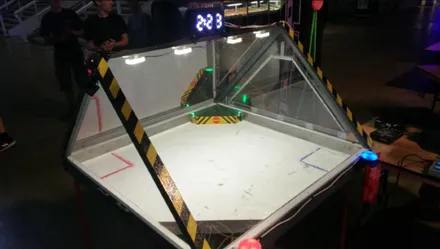 A polycarbonate robot combat arena with lighting and a match timer